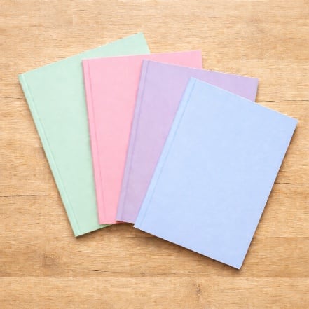 Exercise books covered in assorted pastel colours